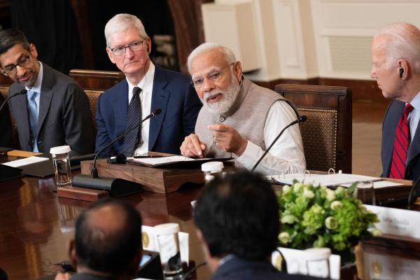 Google CEO Sundar Pichai, Apple CEO Tim Cook, and US President Joe Biden look on as India's Prime Minister Narendra Modi speaks during a meeting with senior officials and CEOs of American and Indian companies in the White House on June 23, 2023. (Photo by Brendan Smialowski / AFP via Getty Images)