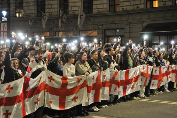  Demonstrators hold a Georgian flag during a protest against the “foreign agents” bill after the Georgian Parliament voted through the law on May 15, 2024, in Tbilisi, Georgia.