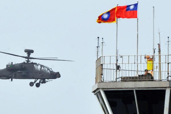 A US-made AH-64E Apache attack helicopter flies during a ceremony in an army airborne special force unit in Tainan, southern Taiwan on December 13, 2013. (Mandy Cheng/AFP/Getty Images)