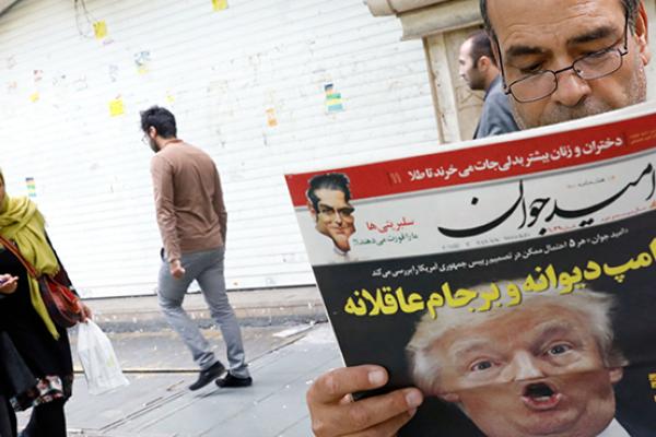 Iranian man reads a newspaper with the headline "Crazy Trump and logical JCPOA," October 14, 2017 