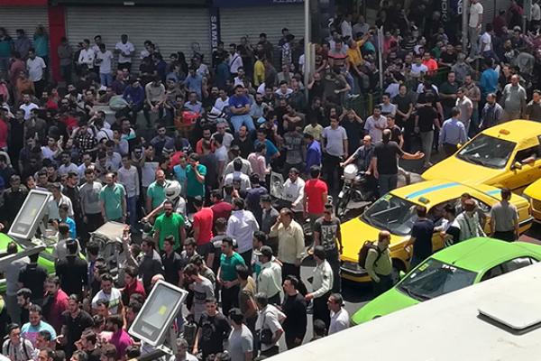 Iranian protesters shout slogans during a demonstration in central Tehran, June 25, 2018 