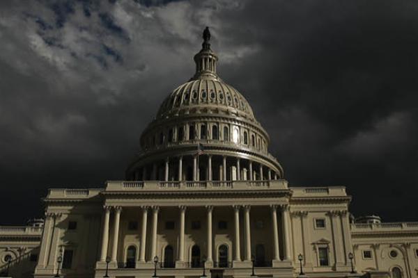 Dark clouds roll past the U.S. Capitol in Washington, D.C. (Getty Images)