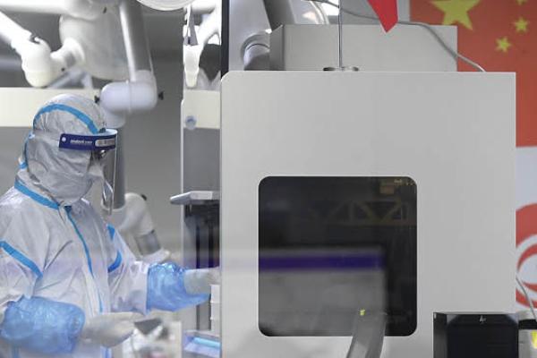 Laboratory technicians wearing personal protective equipment (PPE) working on samples to be tested for the Covid-19 coronavirus. (Getty Images)