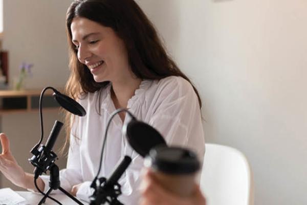 Optimistic influencer talking during broadcast. (Getty Images)