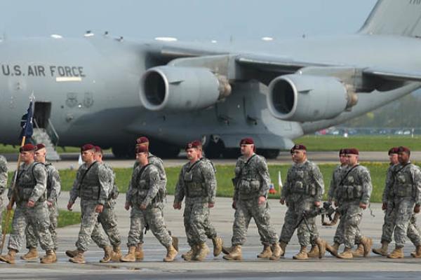 Members of the U.S. Army 173rd Airborne Brigade disembark upon their arrival by plane at a Polish air force base on April 23, 2014, in Swidwin, Poland. (Getty Images)