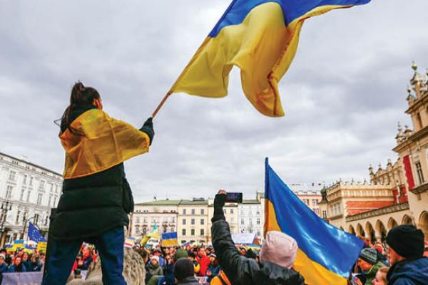 A protester is seen waving a Ukrainian flag during a demonstration in Krakow, Poland on February 27, 2022. (Getty Images)