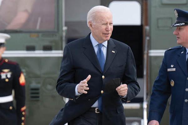 U.S. President Joe Biden is greeted by Colonel Matthew Jones, Commander, 89th Airlift Wing, at Joint Base Andrews in Maryland, on March 23, 2022. (Getty Images)