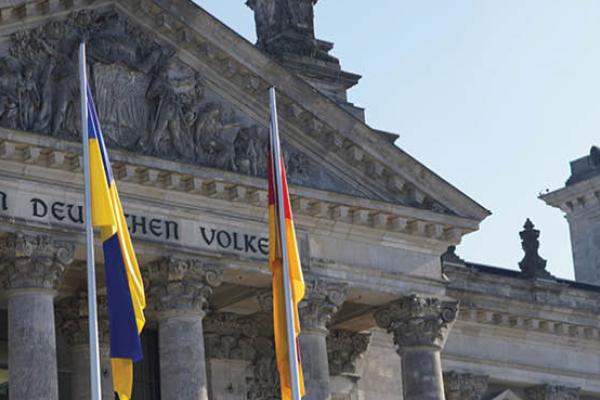 Flags representing the EU, Ukraine, and Germany fly in front of the Reichstag in Berlin, Germany, during a special session of the Bundestag. (Getty Images)