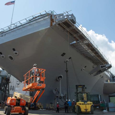 US Navy sailors and Newport News Shipbuilding workers reinstall the port side anchor onboard the Nimitz-class aircraft carrier USS John C. Stennis in Newport News, Virginia, on August 18, 2023. (US Navy)