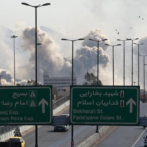 Vehicles drive along an expressway as smoke rises after an air strike in Tehran on March 5, 2026. (Getty Images)