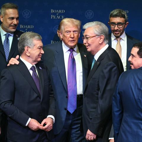 US President Donald Trump (C), flanked by President of Kazakhstan's President Kassym-Jomart Tokayev (R) and Uzbekistan's President Shavkat Mirziyoyev (L), gathers with leaders during a group photo during the inaugural meeting of the "Board of Peace" at the US Institute of Peace in Washington, DC, on February 19, 2026. President Trump on Thursday gathers allies to inaugurate the "Board of Peace," his new institution focused on progress on Gaza but whose ambitions reach much further. Around two dozen world le